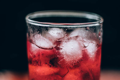 Close-up of beer glass against black background