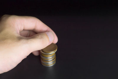 Close-up of a hand holding stack of a candle