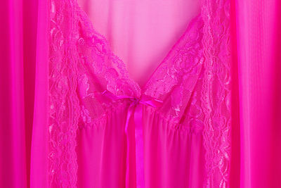 Full frame shot of pink nightdress hanging against blue background