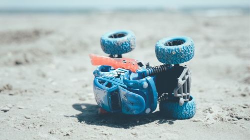 Close-up of toys on beach