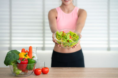 Midsection of woman with healthy food