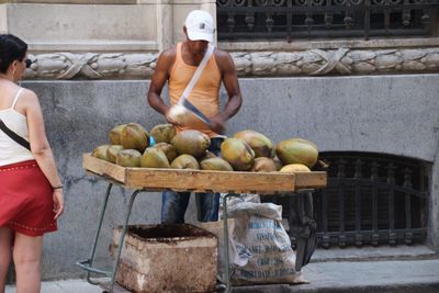 Midsection of man and woman at market stall