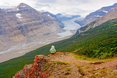 Rear view of man standing on mountain