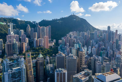 Aerial view of buildings in city against sky