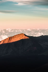 View of volcanic landscape against sky during sunset