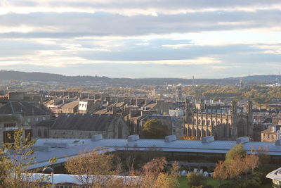 High angle view of cityscape against cloudy sky