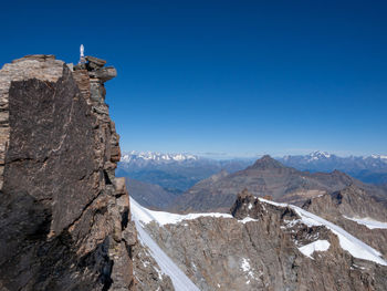 Scenic view of mountains against clear blue sky