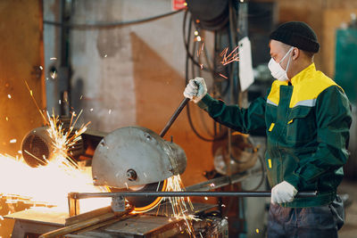 Rear view of man working in workshop