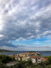 High angle view of townscape by sea against sky