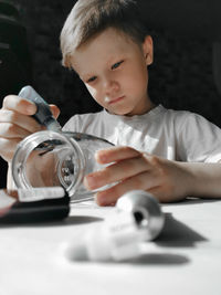 Portrait of boy holding table