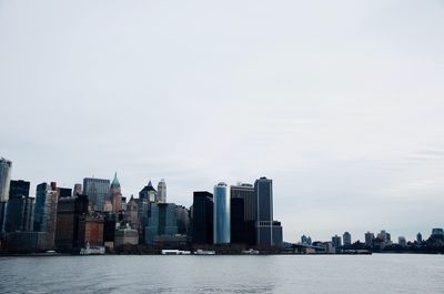 Sea and cityscape against sky