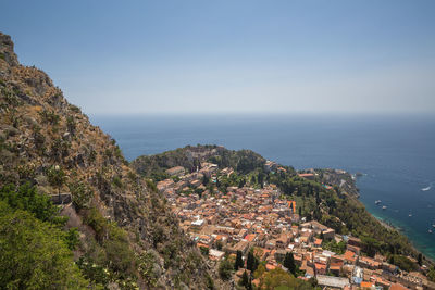 High angle view of townscape by sea against sky