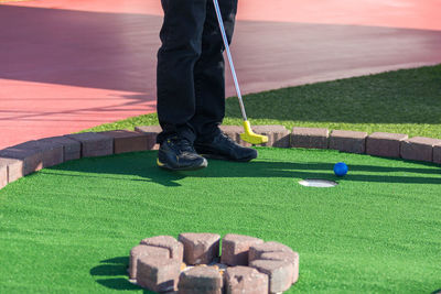 Low section of man playing golf