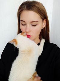 Close-up of beautiful young woman with cat
