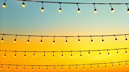 Low angle view of illuminated lights hanging from ceiling