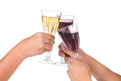 Midsection of woman holding drink against white background