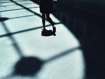 Low section of woman walking on floor