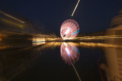 Illuminated ferris wheel at night