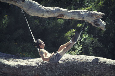 Young woman sitting on rock