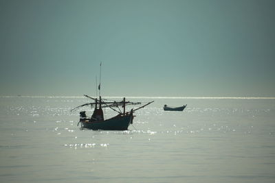 Silhouette boat in lake