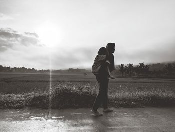 Full length of man standing on field against sky