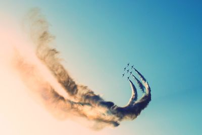 Low angle view of airplane flying against sky