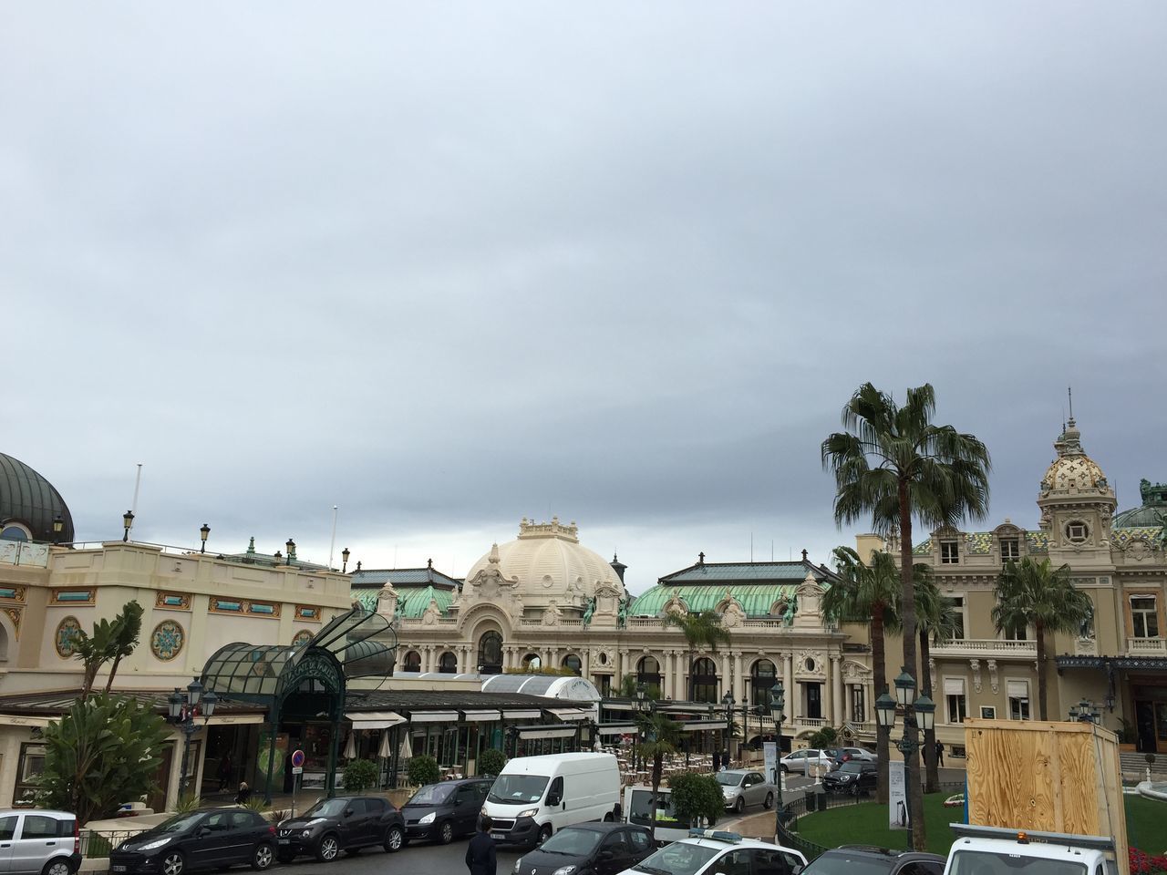 TRAFFIC ON STREET BY BUILDINGS AGAINST SKY