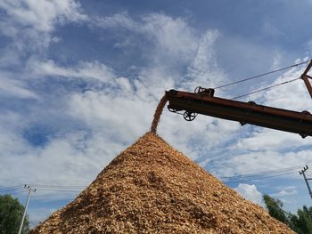 Low angle view of crane against blue sky