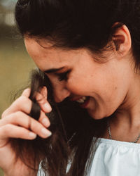 Close-up of young woman holding hair