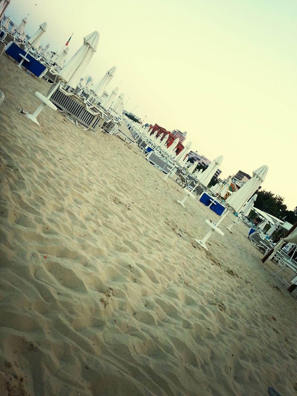 beach, sand, large group of objects, clear sky, copy space, day, no people, arrangement, in a row, transportation, outdoors, shore, abundance, group of objects, absence, mode of transport, sunlight, sea, moored, nature