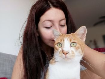 Portrait of beautiful young woman with cat