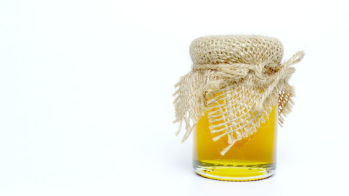 Close-up of yellow jar against white background