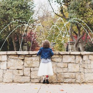 Rear view of child at fountain