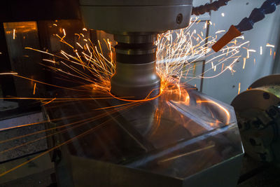 Close-up of illuminated machine in factory