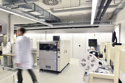 Man walking in a factory for manufacturing of circuit boards for the electronics industry