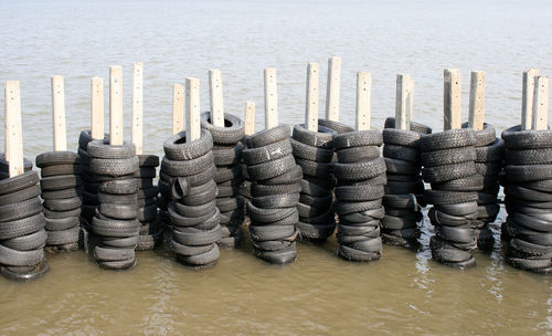 Stack of firewood by sea in row