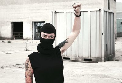 Portrait of man standing against building