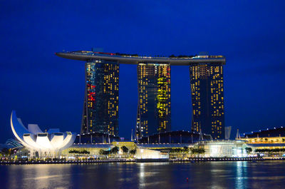 Low angle view of city lit up at night