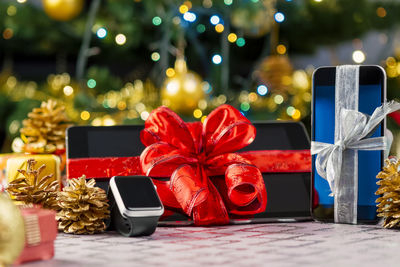 Close-up of digital tablet with decorations on table