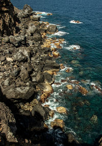 High angle view of rock formation on beach