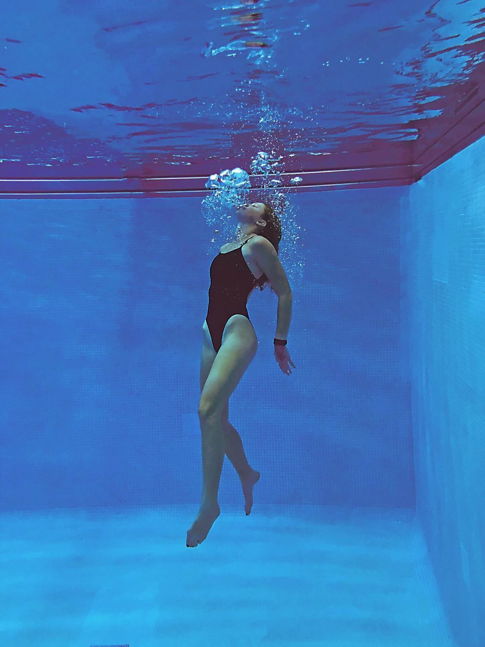 WOMAN SWIMMING IN POOL