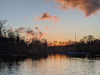 Scenic view of lake against sky at sunset