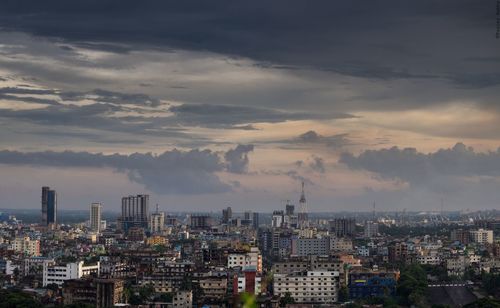 High angle view of cityscape against cloudy sky during sunset