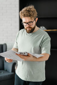 Portrait of young man reading book