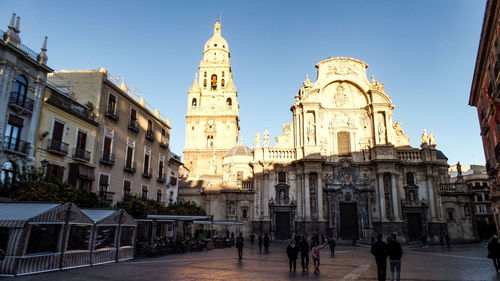 Group of people in front of buildings in city