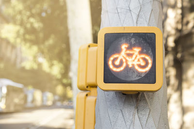 Close-up of bicycle sign on pole