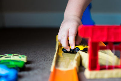 Close-up of child playing with toy cars