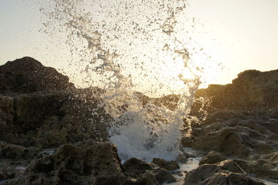 Close-up of sea waves splashing on rocks