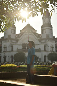 Man by historic building against sky