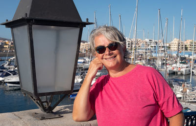 Portrait of smiling woman standing by large lantern